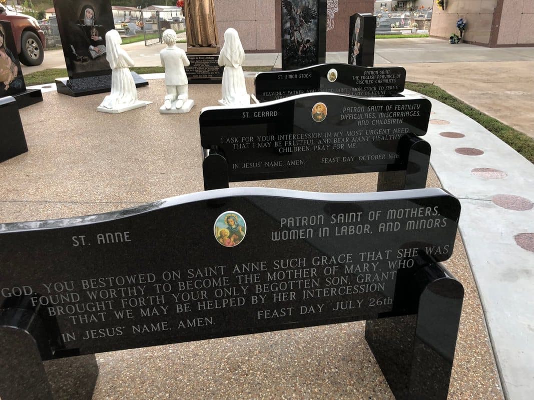 Black granite benches etched with prayers and a portrait of St. Anne.