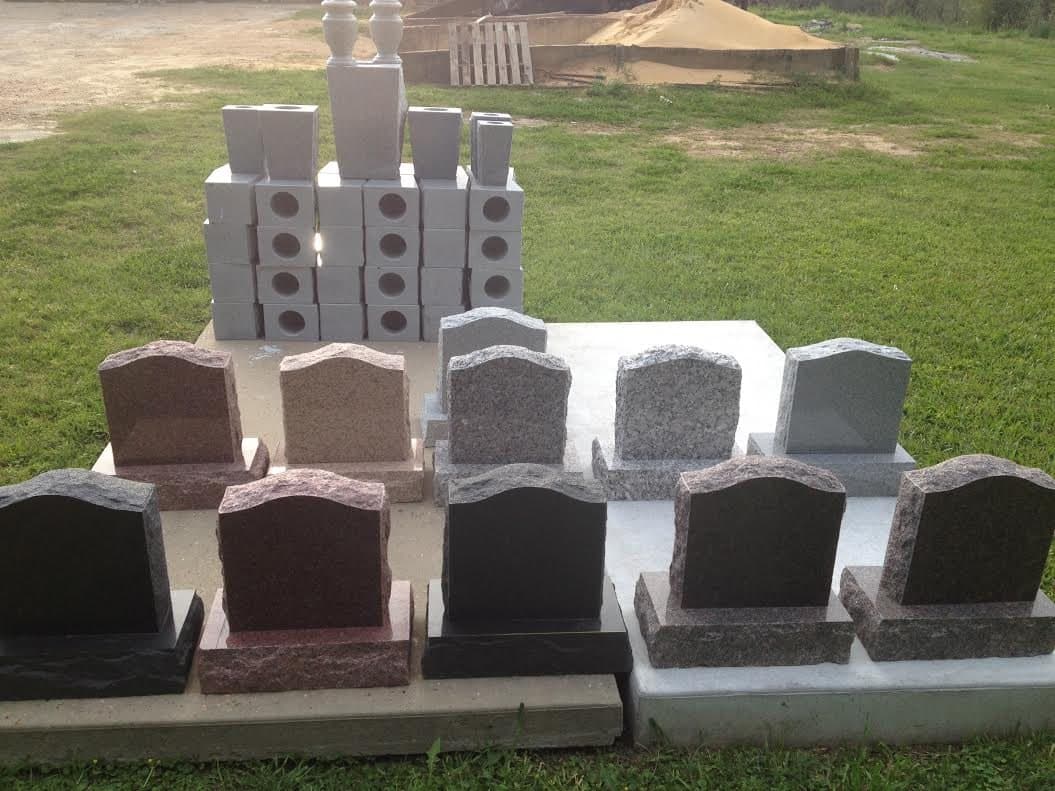 Headstone samples in several granite colors lined up side by side for comparison.
